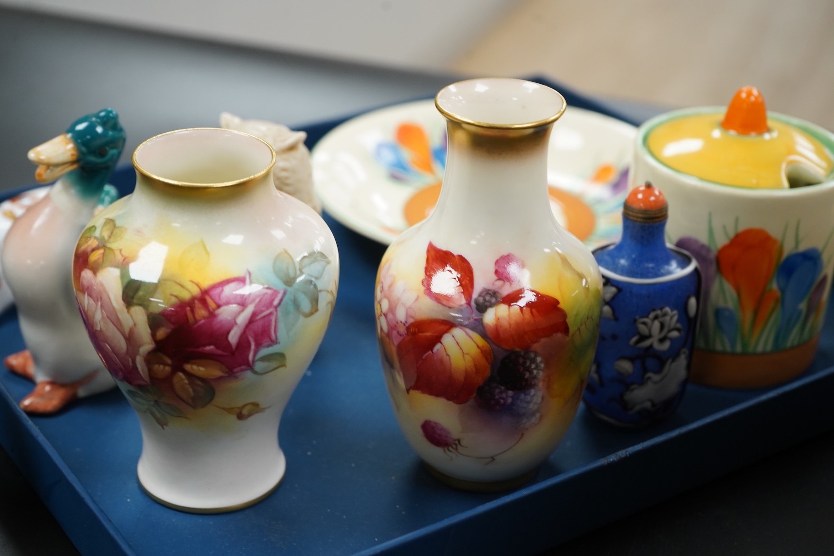 A collection of mixed porcelain and pottery to include four Worcester vases, one signed H. Blake, Clarice Cliff crocus pattern cup, saucer and sugar bowl and two Doulton Imari paperweights, largest 13cm high